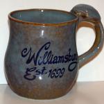 MU 1401                     $6.00

THIS WILLIAMSBURG MUG HAS A SHELL DECORATING THE HANDLE.